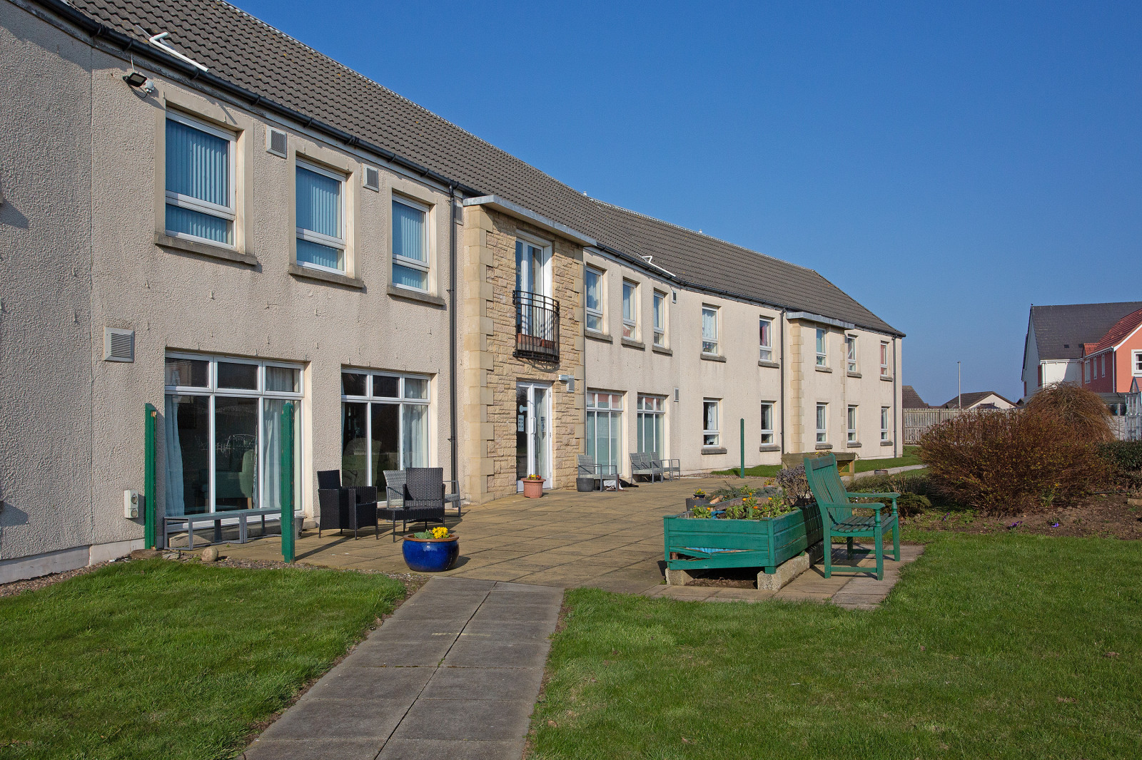 Willow House Care Home garden area with landscaped grounds and  garden room